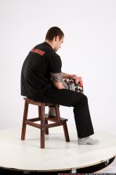 Alex Sitting With Pistol Pose